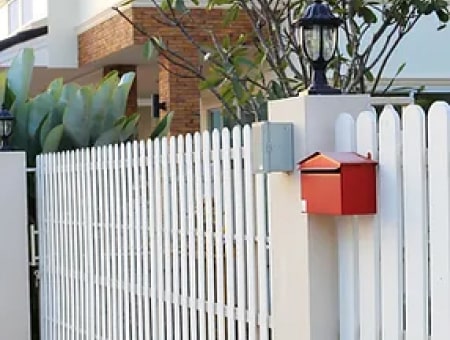 white fence with red mail box